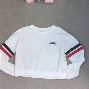 women’s cropped white “local dreamer” sweatshirt.